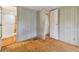 Simple bedroom with wood floors and access to bathroom at 5353 Comanche St, Zephyrhills, FL 33542