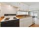 Kitchen with white cabinets and wood countertops at 5353 Comanche St, Zephyrhills, FL 33542