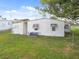 Single-wide mobile home with long covered carport at 5353 Comanche St, Zephyrhills, FL 33542