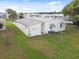 Single-wide mobile home with long covered carport at 5353 Comanche St, Zephyrhills, FL 33542