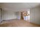 Spacious living room with laminate flooring and access to kitchen at 5353 Comanche St, Zephyrhills, FL 33542
