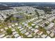 Aerial view of a manufactured home community with a lake at 5353 Comanche St, Zephyrhills, FL 33542