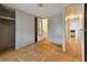 Spacious bedroom with wood flooring and access to other rooms at 5353 Comanche St, Zephyrhills, FL 33542