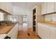 Kitchen with white cabinets and wood countertops at 5353 Comanche St, Zephyrhills, FL 33542