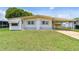 Single-wide manufactured home with carport and well-maintained lawn at 5353 Comanche St, Zephyrhills, FL 33542