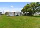Spacious backyard with large tree and grassy area at 5353 Comanche St, Zephyrhills, FL 33542