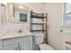 Bright bathroom with white vanity, toilet and shelf at 5353 Comanche St, Zephyrhills, FL 33542