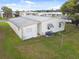 Single-wide mobile home with long covered carport at 5353 Comanche St, Zephyrhills, FL 33542