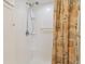 Shower with floral curtain and built-in shelves at 5353 Comanche St, Zephyrhills, FL 33542