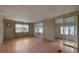 Bright living room featuring laminate floors and sliding glass doors at 5353 Comanche St, Zephyrhills, FL 33542