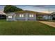 Single-wide manufactured home with carport and well-maintained lawn at 5353 Comanche St, Zephyrhills, FL 33542
