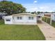 Single-wide mobile home with carport and spacious yard at 5353 Comanche St, Zephyrhills, FL 33542