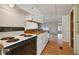 Efficient kitchen with white cabinets and laminate flooring at 5353 Comanche St, Zephyrhills, FL 33542
