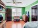Bedroom featuring green walls, hardwood floors, and ample closet space at 510 Tighe Ave, Seffner, FL 33584