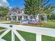Blue house with a wrap-around porch and white picket fence at 510 Tighe Ave, Seffner, FL 33584