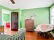 Bedroom with green walls, hardwood floors, and vintage dresser at 510 Tighe Ave, Seffner, FL 33584