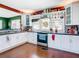 Bright kitchen with white cabinets, stainless steel appliances, and wood floors at 510 Tighe Ave, Seffner, FL 33584