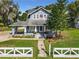 Charming blue house with a wrap-around porch and white picket fence at 510 Tighe Ave, Seffner, FL 33584