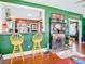 Kitchen with yellow barstools and a pass-through to the living room at 510 Tighe Ave, Seffner, FL 33584