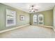 Bedroom with neutral carpet, crown molding, ceiling fan, and arched windows at 4108 W San Luis St, Tampa, FL 33629