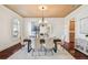 Bright dining room featuring wood floors, chandelier, two arched windows, and neutral decor at 4108 W San Luis St, Tampa, FL 33629