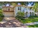 Stunning two-story home with a red tile roof, arched entryway, and lush landscaping at 4108 W San Luis St, Tampa, FL 33629