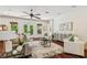 Bright living room with hardwood floors, white furniture, and access to the outdoors at 4108 W San Luis St, Tampa, FL 33629