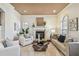 Inviting living room featuring a fireplace, mantel, neutral decor, recessed lighting, and plenty of natural light at 4108 W San Luis St, Tampa, FL 33629