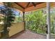 Covered brick patio with wrought iron railing overlooking lush tropical landscape at 4108 W San Luis St, Tampa, FL 33629