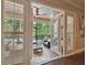 French doors open to a screened patio with comfortable seating and lush landscaping at 5013 W Leona St, Tampa, FL 33629