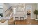 Modern wet bar with white cabinets and a view of the gym at 5013 W Leona St, Tampa, FL 33629