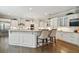Modern white kitchen boasts stainless steel appliances and a spacious island with seating at 5013 W Leona St, Tampa, FL 33629