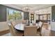 Formal dining room with a round table, six chairs, and large windows at 5013 W Leona St, Tampa, FL 33629
