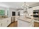 Gourmet kitchen with expansive island, stainless steel appliances, and white cabinetry at 5013 W Leona St, Tampa, FL 33629