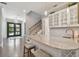 Modern wet bar with white cabinetry and a marble countertop, near the entryway at 5013 W Leona St, Tampa, FL 33629