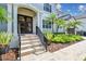 Inviting home exterior with double doors, lush landscaping, and a stone walkway at 5013 W Leona St, Tampa, FL 33629
