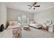 Spacious bedroom with twin beds, a ceiling fan, and plenty of natural light at 5013 W Leona St, Tampa, FL 33629