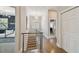 Upstairs hallway with hardwood floors, a modern railing, and access to laundry and bedrooms at 5013 W Leona St, Tampa, FL 33629