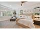 Spacious main bedroom with plush bed, large windows, and sitting area at 5013 W Leona St, Tampa, FL 33629