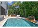 Refreshing pool with stone waterfall feature and plenty of lounge space at 5013 W Leona St, Tampa, FL 33629