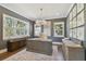 Elegant home office featuring a large desk, hardwood floors, and natural light at 5013 W Leona St, Tampa, FL 33629
