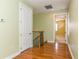 Upstairs hallway with wood floors and access to bedrooms at 10426 La Mirage Ct, Tampa, FL 33615