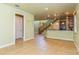 Open living room with tile floors and view of kitchen and staircase at 10426 La Mirage Ct, Tampa, FL 33615