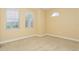Bedroom with carpet, large window and an arched window at 10426 La Mirage Ct, Tampa, FL 33615