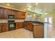 Spacious kitchen with dark wood cabinets and granite countertops at 10426 La Mirage Ct, Tampa, FL 33615