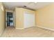Bedroom with carpet, double door closet and access to hallway at 10426 La Mirage Ct, Tampa, FL 33615