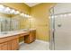 Double vanity bathroom with shower at 10426 La Mirage Ct, Tampa, FL 33615