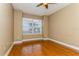 Bright bedroom with wood flooring and large window at 10426 La Mirage Ct, Tampa, FL 33615