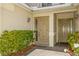 Front entry with double doors and neatly landscaped shrubs at 10426 La Mirage Ct, Tampa, FL 33615