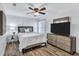 Cozy bedroom with a queen-size bed and wood-look floors at 805 Woodcarver Ln, Brandon, FL 33510